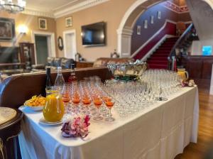 a table with many wine glasses on it at Newcastle House Hotel in Longford