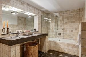 a bathroom with a sink and a tub and a mirror at Villa Mistral Montiboli by Buccara in Villajoyosa +19 photos