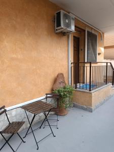 a patio with two chairs and a table and a heater on a balcony at Terry Road House in Monterotondo