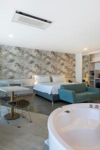 a bedroom with a bed and a bath tub at Hotel Black Tower Premium in Bogotá