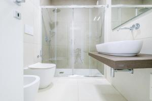 a bathroom with a shower and a toilet and a sink at Le Cammire Luxury Apartment - Leuca in Leuca