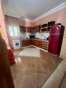 a kitchen with a red refrigerator in a room at Dream Villa with Private Pool in Taguermess +7 photos