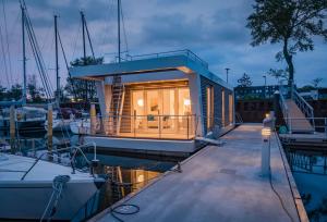 een kleine boot is aangemeerd bij een jachthaven bij Hausboot Maritim Holiday in Großenbrode