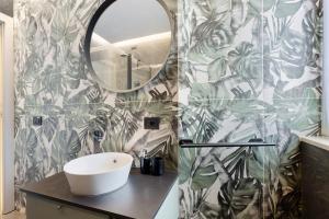 a bathroom with a sink and a mirror at Dalma in Peschiera del Garda +12 photos