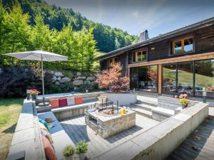 an outdoor patio with a fire pit and a house at Chalet Colombine - OVO Network in Les Villards-sur-Thônes