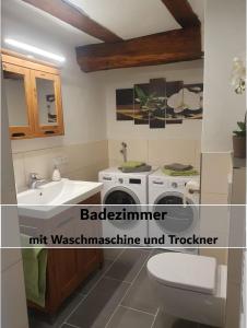 a bathroom with a sink and a toilet at Fachwerk zum Entspannen, max. 3P in Bad Emstal