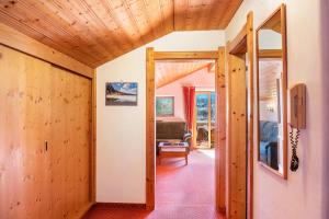 a room with wooden walls and a hallway with a doorway at Alpenblick Tilly Fewo Walchensee 5 in Krün