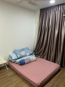 a bed sitting in a room with a window at Ady's 737 in Kuala Lumpur