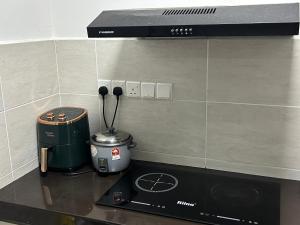 a stove top with a coffee maker on a counter at Ady's 737 in Kuala Lumpur