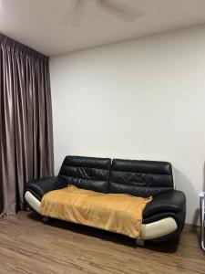 a black leather couch sitting in a room at Ady's 737 in Kuala Lumpur