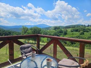 a table and chairs on a balcony with a view at Goč Sunčani breg in Stanišinci