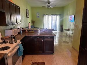a kitchen with a sink and a stove at J&L beachfront bliss steps to sand an sunset views in Rolleville +6 photos