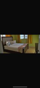 a bedroom with a bed and a laptop on it at J&L beachfront bliss steps to sand an sunset views in Rolleville