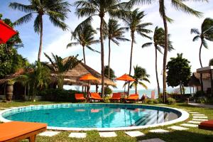 a pool with chairs and umbrellas and palm trees at Secret Garden Beach Resort in Bangrak Beach +37 photos