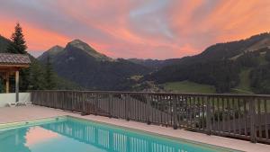 a swimming pool with a view of a mountain at Chalet Pip - Modern chalet with breathtaking views in Morzine