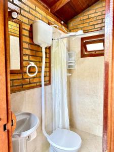 a bathroom with a toilet and a sink at Pousada Porto Belo in Porto Belo