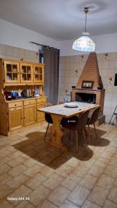 a kitchen with a table with chairs and a stove at Casa bolsena in Gradoli