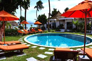 a pool at a resort with chairs and umbrellas at Secret Garden Beach Resort in Bangrak Beach