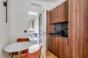 a small kitchen with a table and a counter at Maison du Moulin Vert in Paris
