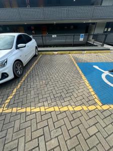 a white car parked in a parking lot at Apt Alto da Serra Villas - Bananeiras in Bananeiras