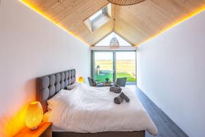 a bedroom with a large bed and a window at The Ark 4 in Southwold