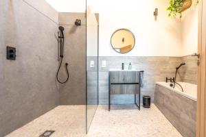 a bathroom with a shower and a sink and a tub at The Ark 4 in Southwold +37 photos