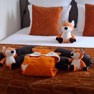 a group of stuffed animals sitting on a bed at Le Renard'or in Trois-Ponts