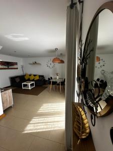 a living room with a couch and a mirror at Casa Milan in Puerto Calero