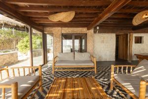 a living room with a couch and a table at Casa Aakbal - Luxury Beach Front Villa in Tulum +67 photos