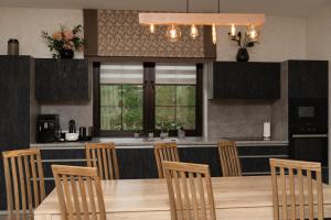 a kitchen with a table and chairs and a bar at Finlandia Chalet in Bukovel