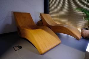 a wooden chair sitting in front of a window at WR SPORT HOTEL & SPA - Centrum Sportu i Rozrywki in Rzeszów