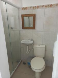 a bathroom with a toilet and a sink and a shower at Hostel Rota do Sol in Cabo Frio +50 photos