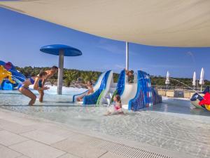 a group of people playing in the water at a water park at Valamar Camping Lanterna - Roan in Poreč