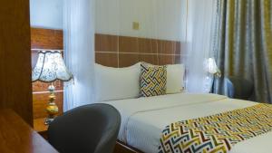 Postel nebo postele na pokoji v ubytování Ambrosia Heights Entebbe