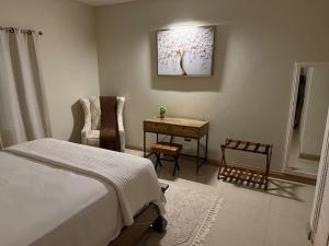 a bedroom with a bed and a table and a desk at Experience Luxury & Serenity-Your Perfect Getaway in Ocho Rios +38 photos