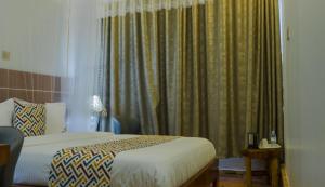 Postel nebo postele na pokoji v ubytování Ambrosia Heights Entebbe