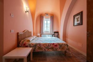 a small bedroom with a bed and a window at La Beccanina Resort in Le Case +115 photos