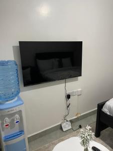 a flat screen tv on the wall of a room at Comfort and charm homes in Nairobi