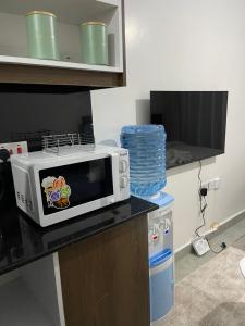 a microwave sitting on a counter in a kitchen at Comfort and charm homes in Nairobi