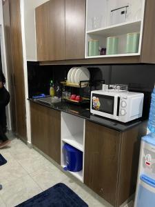 a microwave on a counter in a kitchen at Comfort and charm homes in Nairobi