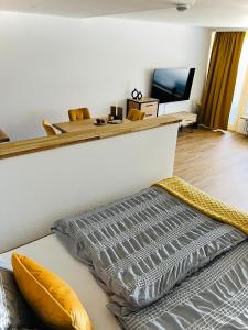 a room with a bed and a flat screen tv at Ferienwohnung Sonneck in Oberstaufen
