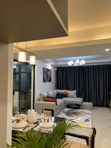 a living room with a couch and a table at Urban Oasis 2BR in Nairobi