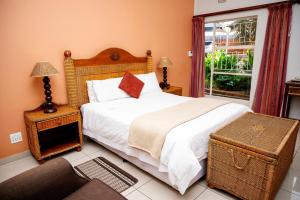 a bedroom with a large bed and a window at Boksburg Boutique Hotel in Boksburg +27 photos