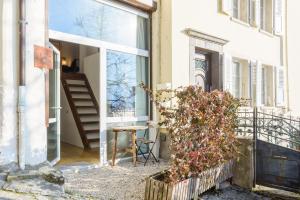 a room with a window and a table on a balcony at Rue du Centre - Lumineux appartement duplex Centre Montreux in Montreux