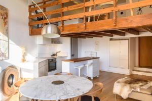 a kitchen and dining room with a table and chairs at Rue du Centre - Lumineux appartement duplex Centre Montreux in Montreux +10 photos