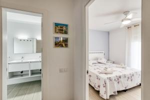 a bedroom with a bed and a sink and a mirror at Casa en Begur reformada in Begur