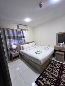 a bedroom with a bed and a desk and a bed sidx sidx sidx at Uncle Ali hotel in Wadi Musa +33 photos