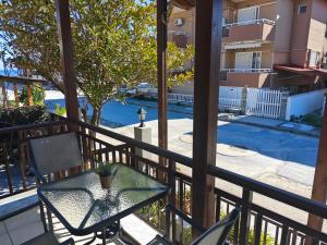 a patio with a table and chairs on a balcony at House Anna Sarti in Sarti