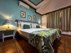 a bedroom with a bed and a table with a lamp at Hotel San Marco  in Santo Domingo +36 photos