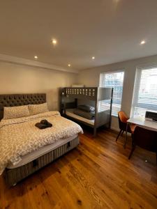a bedroom with a bunk bed and a desk at Keysan House 1 in London